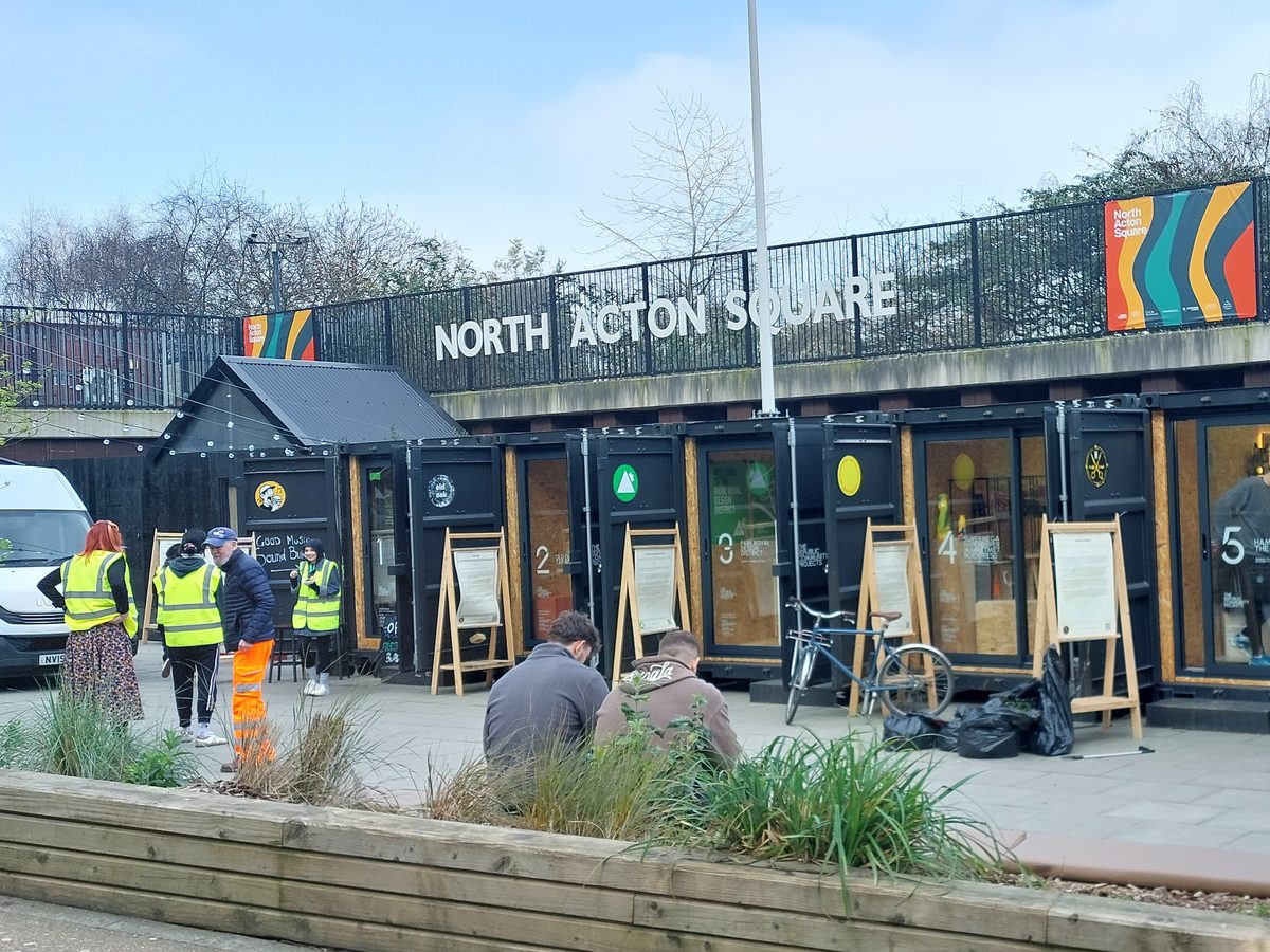 The row of container units beneath the North Acton Square sign